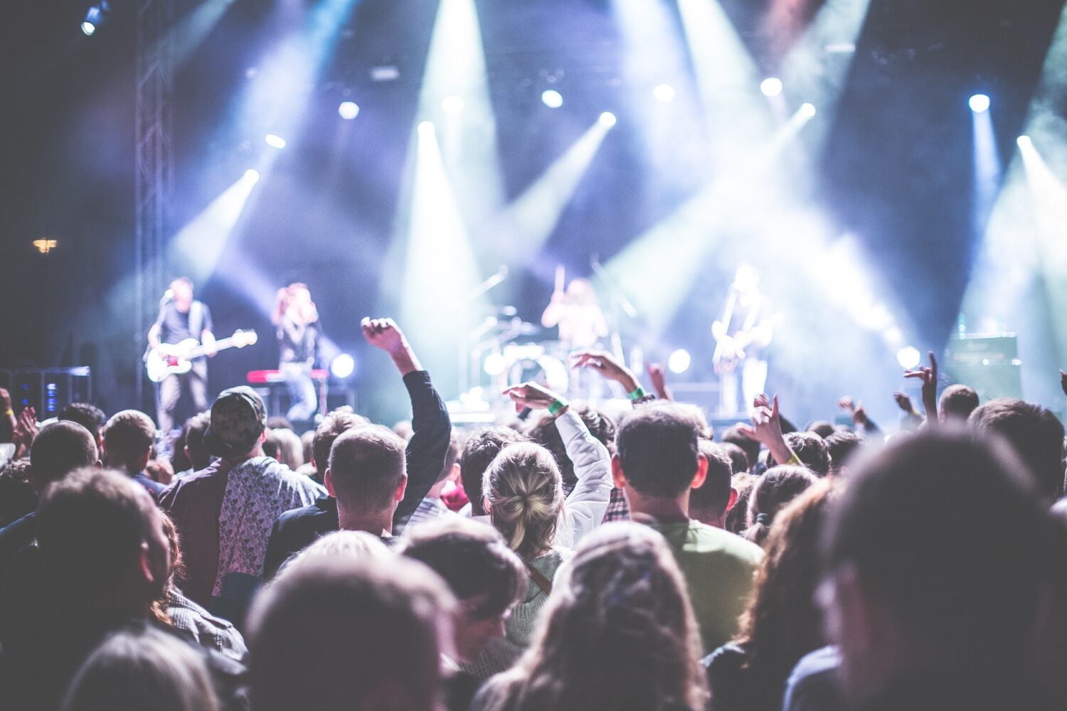 Audience at a concert cheering on the performers. 